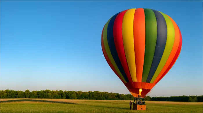 Colorful hot air balloon lifting gently from the ground, symbolizing emotional lightness and healing from depression