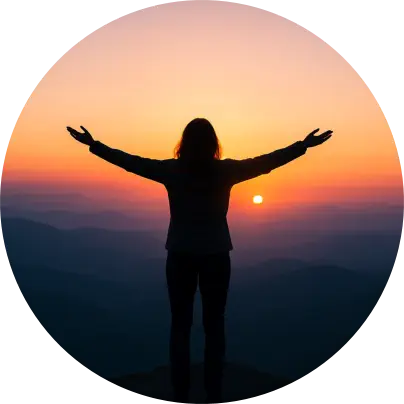 Person standing with arms open at sunrise — representing freedom, healing, and emotional release
